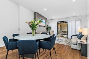 Dining: The large round marble table comfortably seat six. French doors opens to rear. 