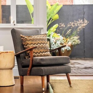 LIVING ROOM: The living room has comfortable mid-century armchairs that are perfect for relaxing and enjoying reading the many books or a cup of coffee.