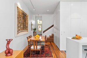 DINING: The timber dining table comfortable seat six.