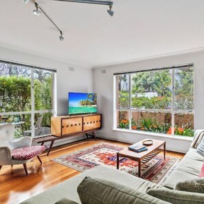 LOUNGE: Collected art work and fine furniture feature in this sunny living room with a garden outlook.