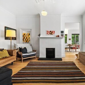 LOUNGE: The lounge with couches and decorative fireplace has a Smart TV and home theatre sound system.