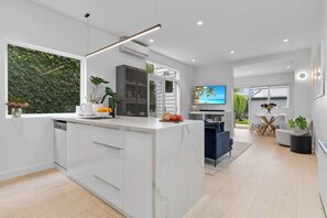 OPEN PLAN: The hall opens to a light and bright open plan kitchen, lounge and dining areas.