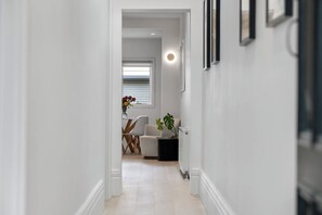 HALL: The light and bright hall flows past the two generous, build in robed queen bedrooms.
