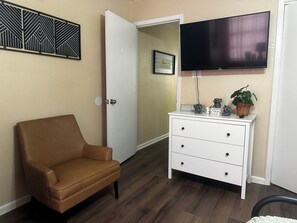Nice comfortable couch in bedroom with smart tv in bedroom too.