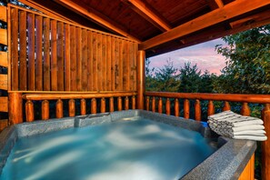 Rejuvenating hot tub on deck surrounded by nature, offering a peaceful escape.