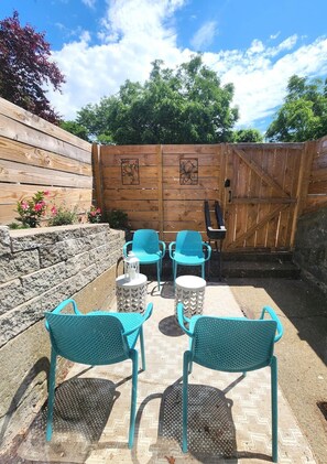 The oversized window by the kitchen table has this view of the private patio