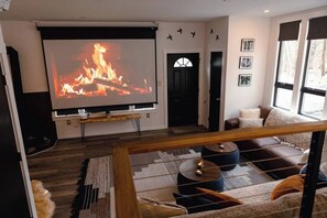 Living room. Huge projector screen and high def projector.