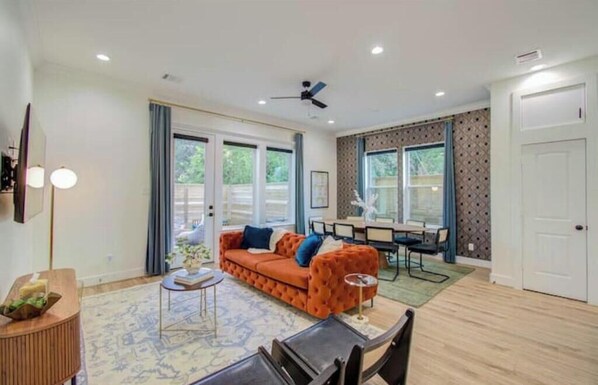 Great natural lighting captured by the living rm windows keeps the room bright