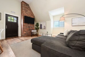 Spacious Living Room With Comfy Couch And Smart TV