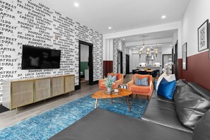 Relax in the living area with a smart TV, stylish seating, and a sleeper sofa for extra guests. Perfect for families or group stays in New Orleans, this inviting space is ideal for movie nights or recharging after a day in the city.