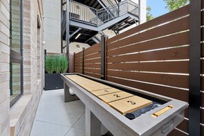 Private patio area with outdoor seating and game