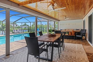Vacation in SW Florida style in this beautiful outdoor space, with dining, living room, heated pool and sun loungers - along a Gulf access canal.