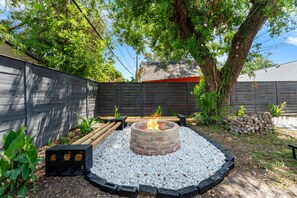 Relax by the cozy fire pit with a rustic custom built seating
