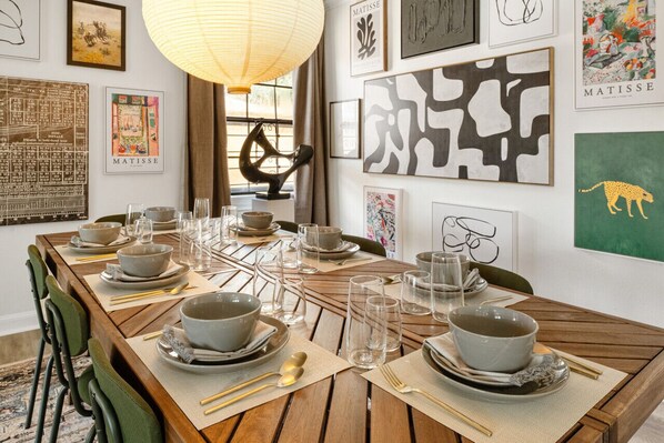 The dining area is beautifully set up with a stylish table arrangement, ready to host your meals in a welcoming and elegant setting.