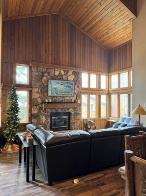 Large sitting area in front of wood burning fireplace and smart TV (The Frame).