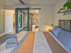 Master bedroom with ceiling fans, mirror and wardrobe.