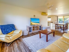 Spacious living room with plenty of seating and a smart TV.