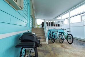 Spacious side patio with barbecue and seating.