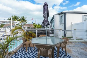 Relaxing deck with marina views and palm trees