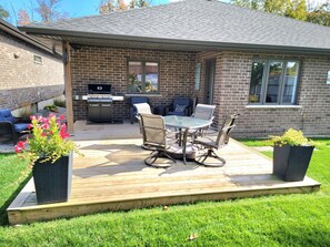 Outdoor seating area complete with gas grill.