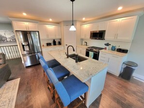 Well equipped kitchen with quartz countertops. Gas cook top & dishwasher.