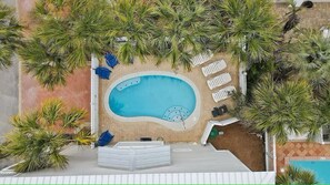 Overview of pool area, lush tropics surround you
