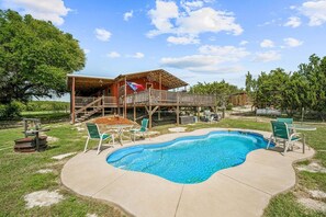 The pool area is a highlight of the property, offering a large swimming pool with a deep end reaching 6 feet. This is the perfect place to cool off and enjoy sunny days with family and friends.