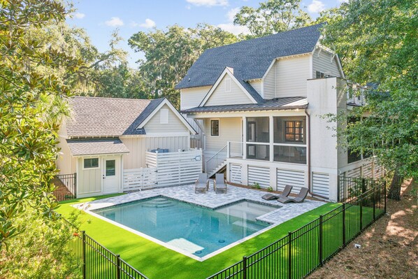 Backyard: private pool with tanning ledge, outdoor bathroom and large fenced yard with astroturf surrounding the pool area.