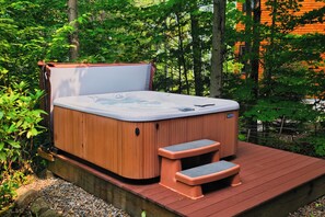 Relaxing outdoor hot tub surrounded by nature, offering the perfect spot to unwind and enjoy the peaceful surroundings after a long day of adventure.