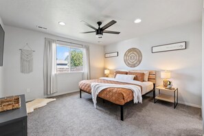 Super comfy King size bed with a ceiling fan and 55" Roku Smart TV.