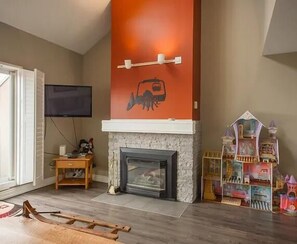 Enjoy a cozy evening by the gas fireplace in this charming and inviting living area.