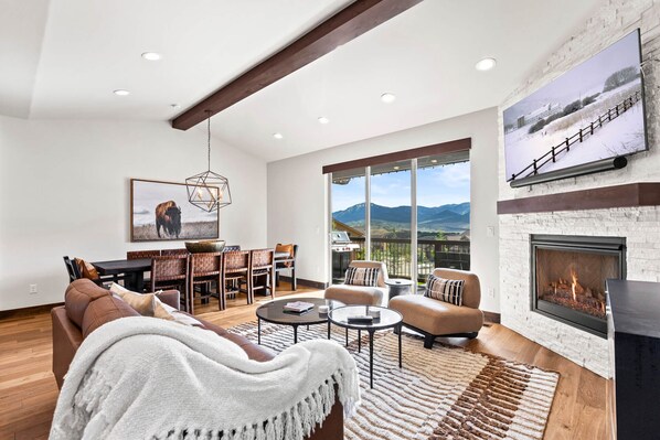 Black Rock Ridge 14544: Cozy space with dining table, sofa, and access to outdoor patio.