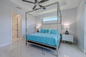 Stylish Bedroom - - Rest in comfort with a sleek four-poster bed and vibrant bedding adding a touch of elegance
- Minimalist decor and soft lighting create a calming atmosphere for relaxation
- Connected to a private ensuite, offering both convenience and privacy