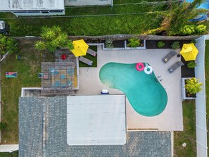 {POOL} Relax by the pool with loungers, floaties, and kids' vests.
