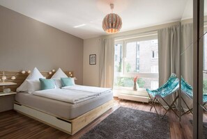 The bright sleeping room with a 1,6 m x 2 m bed, block out curtains and a big wardrobe.