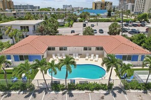 Front building overhead one level, 8 parking spots, 8 units, 1 spot per unit