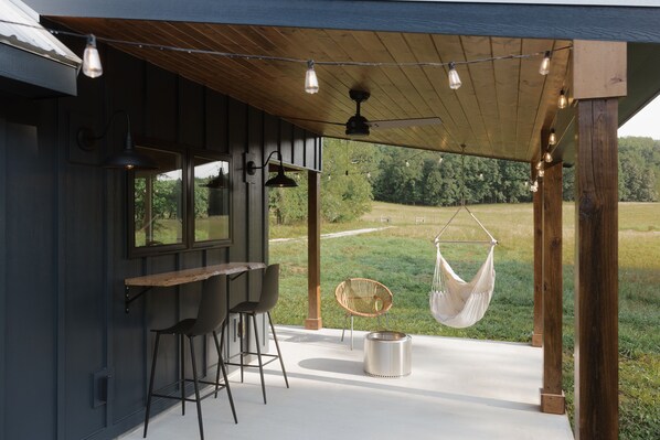 Relax on the patio around the fire pit or in the swing chair