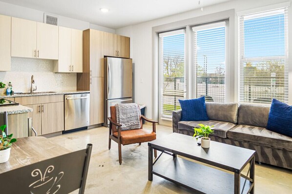 The living room is filled with natural light, creating a bright and welcoming space that invites relaxation.