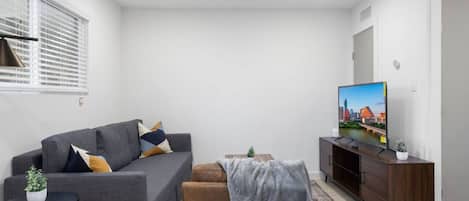 You feel at home as you settle into the living room, where the inviting atmosphere is perfect for lounging or entertaining.