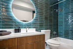 You feel a sense of calm as you enter the bathroom, where the thoughtful design and high-quality materials create a serene environment.
