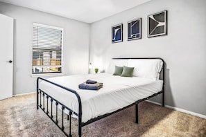 Spacious bedroom with stylish decor, perfect for unwinding after a day of exploring the local area.