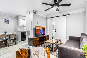 You feel a sense of peace as you step into the living room , with its inviting decor and soothing tones.