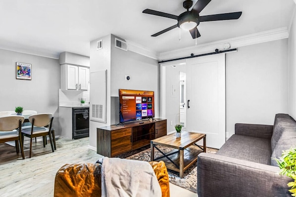 You feel a sense of peace as you step into the living room , with its inviting decor and soothing tones.