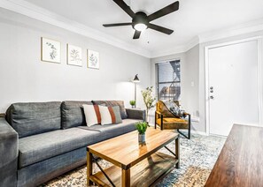 You feel a sense of peace as you step into the living room , with its inviting decor and soothing tones.