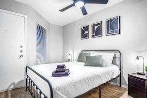 The bedroom’s serene ambiance invites you to relax, with a plush bed that promises a restful night's sleep.