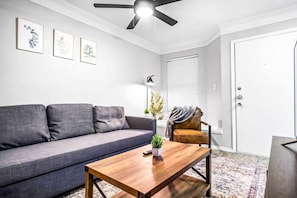The living room’s cozy vibe makes it the perfect spot to relax, with ample seating and a warm ambiance.