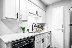 As you open the kitchen, you discover an assortment of coffee pods, and sugar, ensuring you have everything you need for a perfect morning or afternoon pick-me-up.