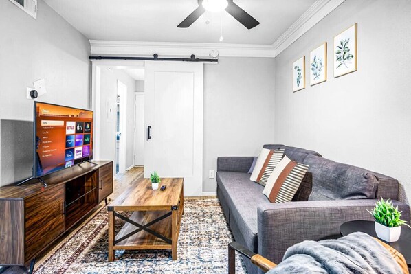 The living room’s cozy vibe makes it the perfect spot to relax, with ample seating and a warm ambiance.