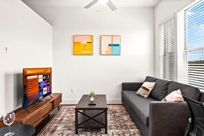 Relax in this warm, inviting space with wooden accents and cozy furnishings. You’ll love unwinding on the plush sofa, enjoying a good book or streaming your favorite shows in a serene atmosphere