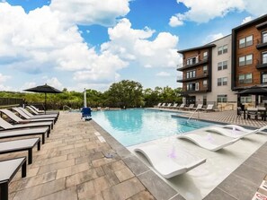 You can imagine yourself lounging by the pool, surrounded by greenery and the gentle sound of water.